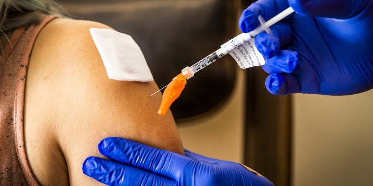 Image: A health care worker administers a dose of the Pfizer-BioNTech Covid-19 vaccine at Boston Medical Center on June 17, 2021.