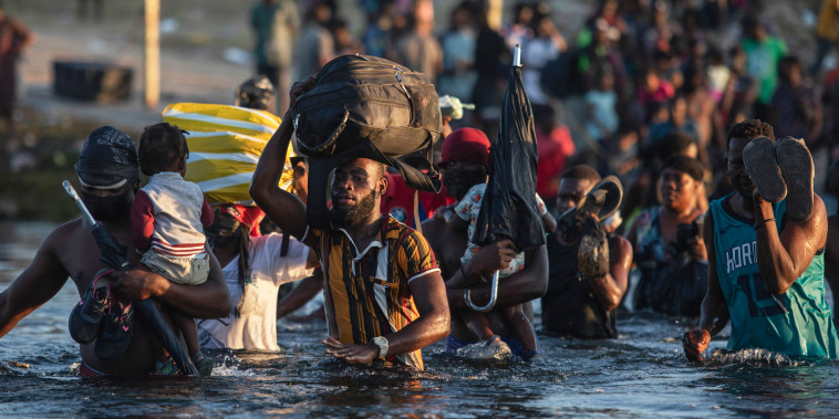 Asylum seekers, many from Haiti, wade across the Rio Grande river from Del Rio, Texas, to return to Ciudad Acu?a, Mexico, on Sept. 20, 2021, to avoid deportation from the U.S.