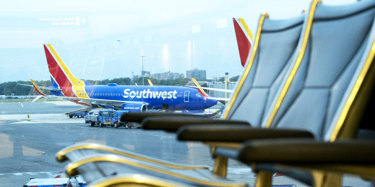 A Southwest Airlines plane remains at the gate at Ronald Reagan National Airport in Arlington, Va., on May 25, 2021.