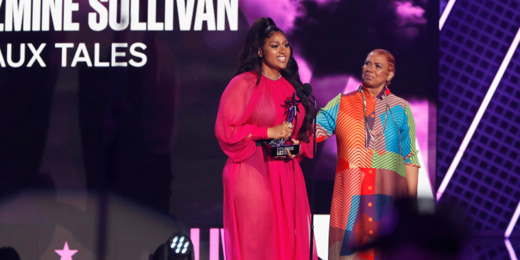 Jazmine Sullivan accepts the Album of the Year award with Pam Sullivan at the BET Awards in Los Angeles on June 27, 2021.