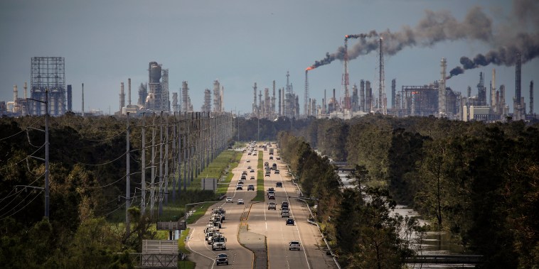 Traffic moves along a stretch of roads near the Royal Dutch Shell and Valero Energy's Norco refineries during a power outage caused by Hurricane Ida in LaPlace, La., on Aug. 30, 2021.
