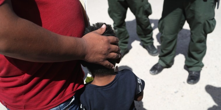 U.S. Border Patrol agents take a father and son from Honduras into custody near the U.S.-Mexico border on June 12, 2018, near Mission, Texas. The asylum seekers were then sent to a U.S. Customs and Border Protection processing center for possible separati
