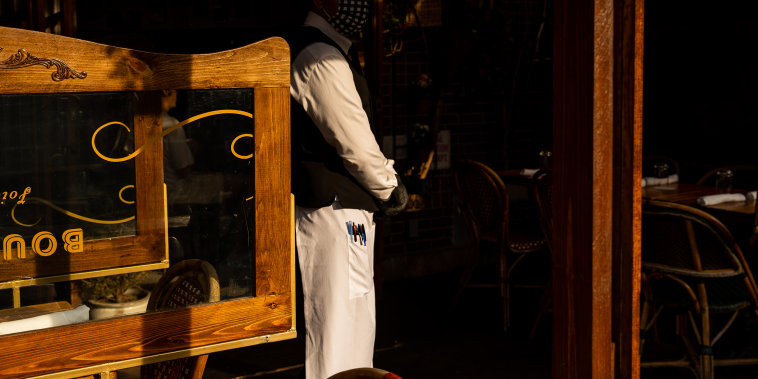 Image: A waiter at a restaurant in the West Village neighborhood of New York on April 28, 2021.