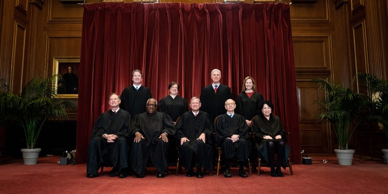 Image: Seated from left, Samuel Alito, Clarence Thomas, John Roberts, Stephen Breyer, Sonia Sotomayor, and second row, from left, Brett Kavanaugh, Elena Kagan, Neil Gorsuch and Amy Coney Barrett at the Supreme Court on April 23, 2021.