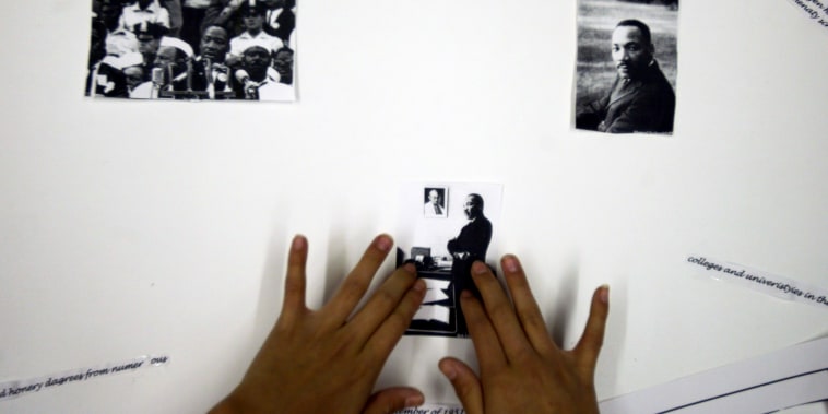 Onamia MN, 2/25/04----Vala Eagle 11,  a  6th grader at Nay Ah Shing school in Onamia puts photographs of  Dr. Martin Luther King  on a poster for Black History month.  Donna Benson is a social studies teacher at Nay Ah Shing school and  the students in he