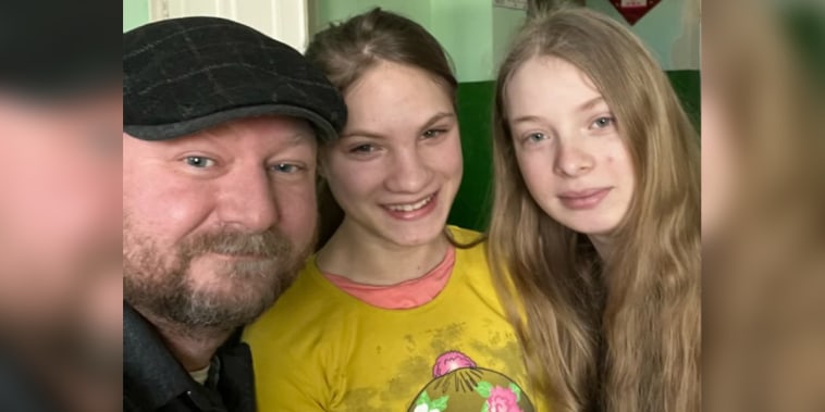 Ukrainian orphans Vika, 15, and Oksana, 13, with Steve Heinemann. Heinemann and his wife Jennifer are in the process of trying to finalize adoption of the girls, who are currently in Ukraine.