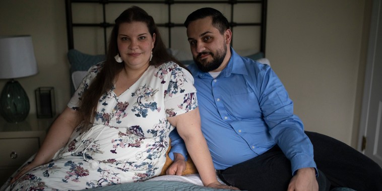 Brienne and Eric Alves sit at home in Akron, OH on April 24, 2022. Brienne and Eric Alves struggled with male infertility when trying to start a family.