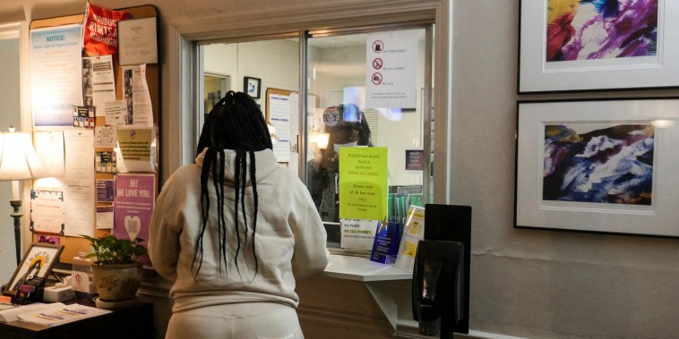A woman stands at the check-in window of the Hope Medical Group for Women in Shreveport, La., on April 19, 2022.