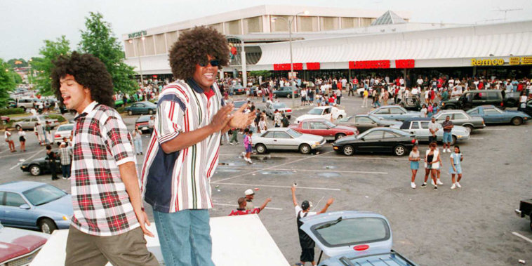 Kool Raul of Memphis, Tenn. and Marcellus Jackson of Raleigh N.C. both party atop of their Utility Van while park in the parking lot of Greenbriar mall where students and residents alike gathered there to celebrate Freaknik on April 1, 1996.