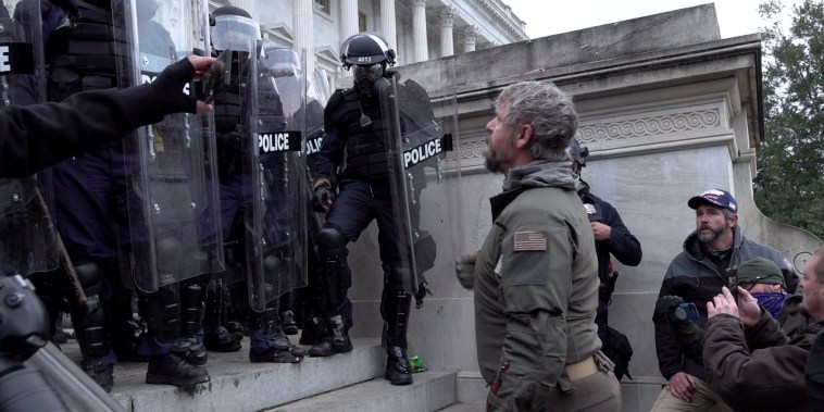 Image: Police stand on the steps of the Capitol and are approached by rioters on Jan. 6, 2022 in Washington.