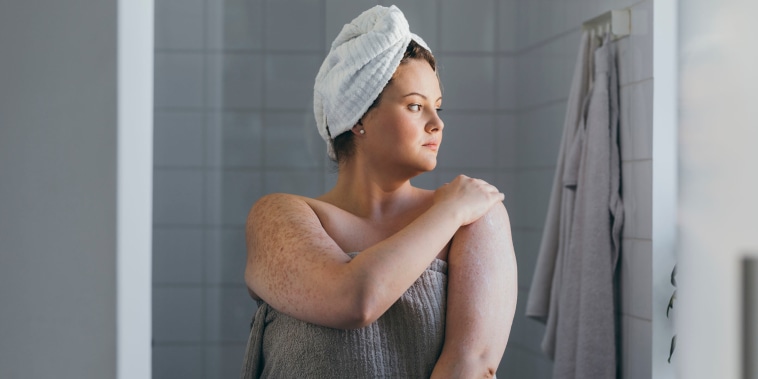 Beautiful Plus Size Woman Applying Body Lotion after Taking a Shower