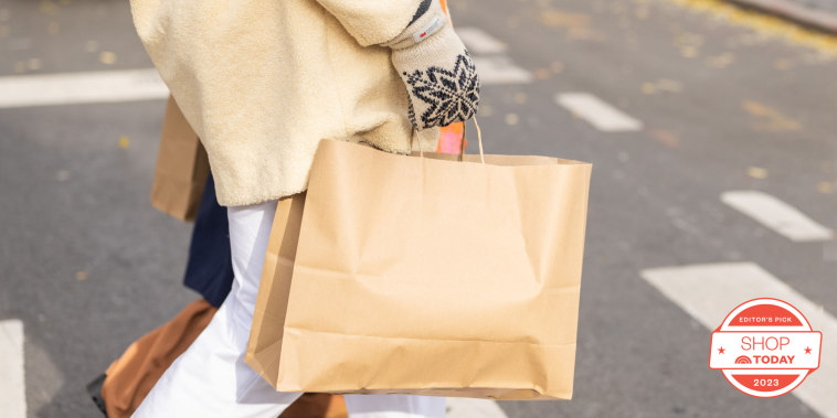 Woman holding shopping bag outside