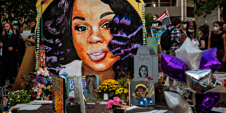 People gather at a makeshift memorial for Breonna Taylor in downtown Louisville, Ky., on Sept. 26, 2020.