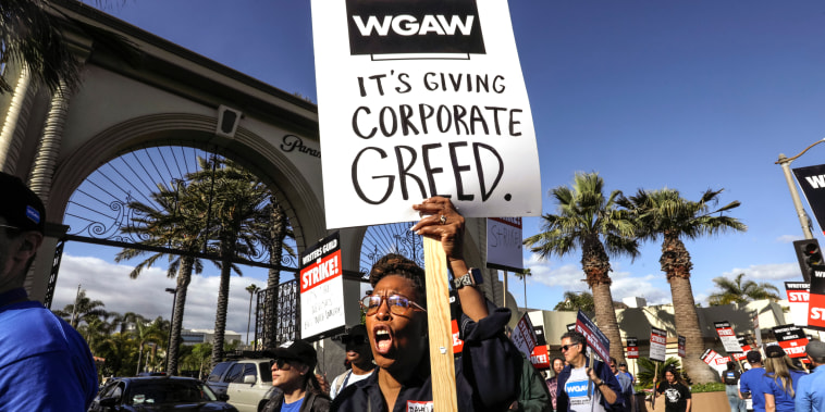 Actor and writer Daheli Hall cheers as she joins WGA members on the first day of their strike in front of Paramount Studios in Hollywood, Calif., on May 2, 2023.