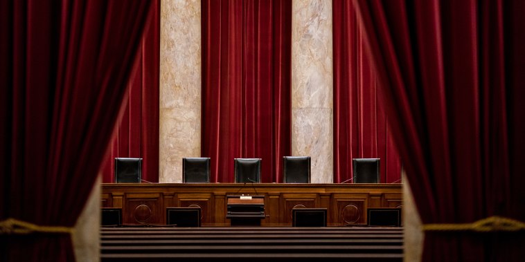 Chairs of U.S. Supreme Court justices sit behind the courtroom bench on July 9, 2019.