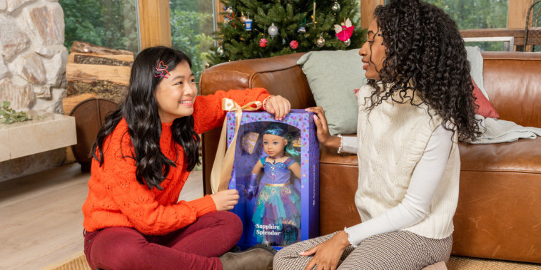 Two friends playing with an American Girl Doll