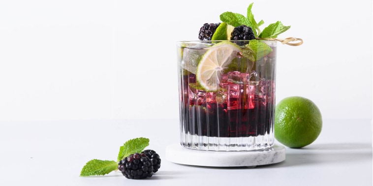 Blackberry mojito cocktail with lime and ice cub