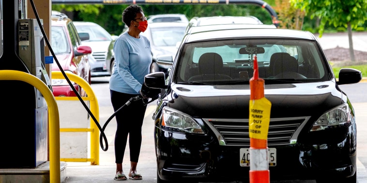 Image: A woman fills her car at a gas station in Annapolis, Md., on May 12, 2021.