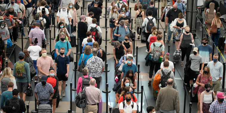 Image: Travelers make their way through the north south security checkpoint at Denver International Airport on July 2, 2021.