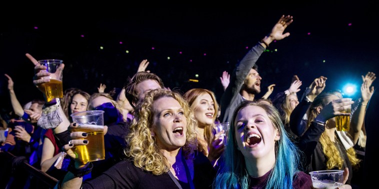 Visitors to the Ziggo Dome attend a performance by Dutch singer Andre Hazes in Amsterdam on March 7 2021 during a series of trial events in which Fieldlab is investigating how large events can take place safely.