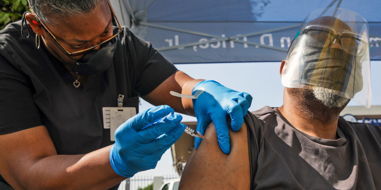 A health worker administers a Pfizer Covid-19 vaccination at a mobile vaccination clinic in Los Angeles on July 16, 2021.