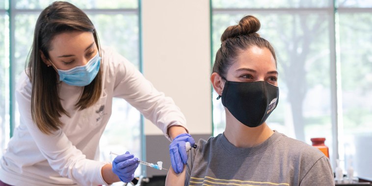 Aggie Health and Wellness Center Nurse Marissa Archuleta administers a Johnson and Johnson Covid-19 vaccine to Lauren Naranjo at a walk in clinic at Corbett Center in Las Cruces, N. M. on May 13, 2021. New Mexico's institutions of higher learning are spearheading efforts to vaccinate young people across the state. With and without vaccine mandates, leaders at colleges and universities say they're on track to increasing vaccination rates on campus to levels far higher than the surrounding community.