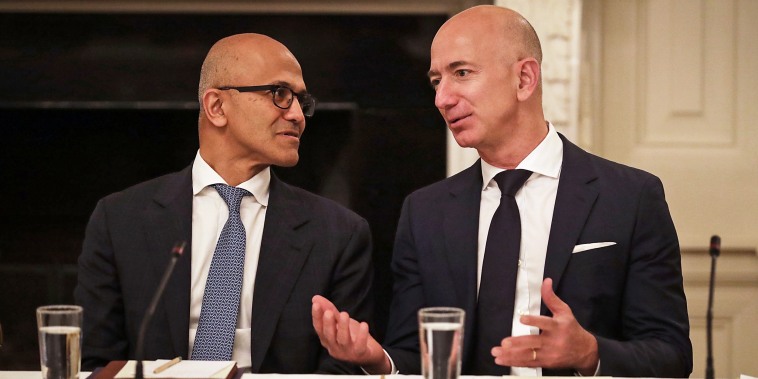 Microsoft CEO Satya Nadella and Amazon CEO Jeff Bezos talk with each other before a meeting of the White House American Technology Council in Washington on June 19, 2017.