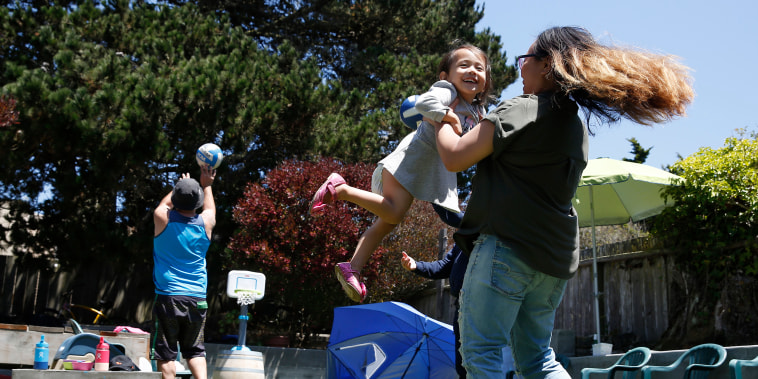 Juliet Palarca, right, celebrates Independence Day during a family barbecue in her backyard on July 4, 2020 in San Francisco.