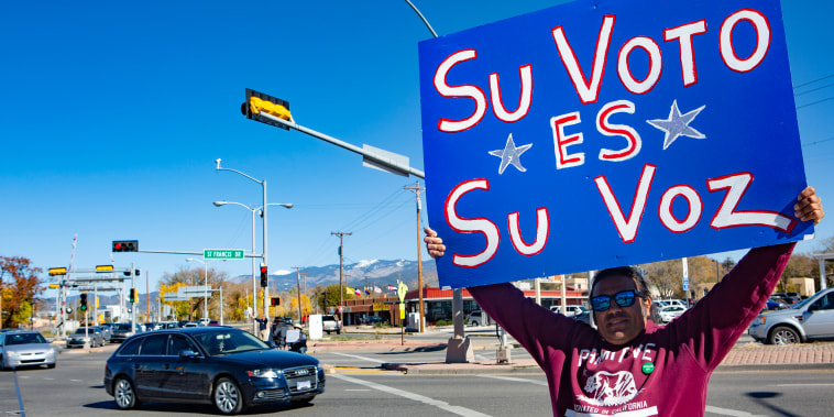 An activists calls on residents to vote in the mid-term elections in  a major intersection in the capital city of Santa Fe, N.M., on  Nov. 6, 2018.