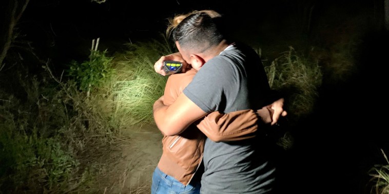 Honduran immigrant Edín Galeano hugs his partner after finding her on the bank of the Rio Grande, Texas, after more than five years without seeing her.
