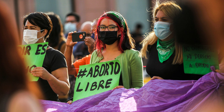 Image: A woman holds a banner which reads "Free abort" during a protest to celebrate the decision of the Supreme Court of Justice of the Nation (SCJN) that declared the criminalization of abortion as unconstitutional, in Saltillo