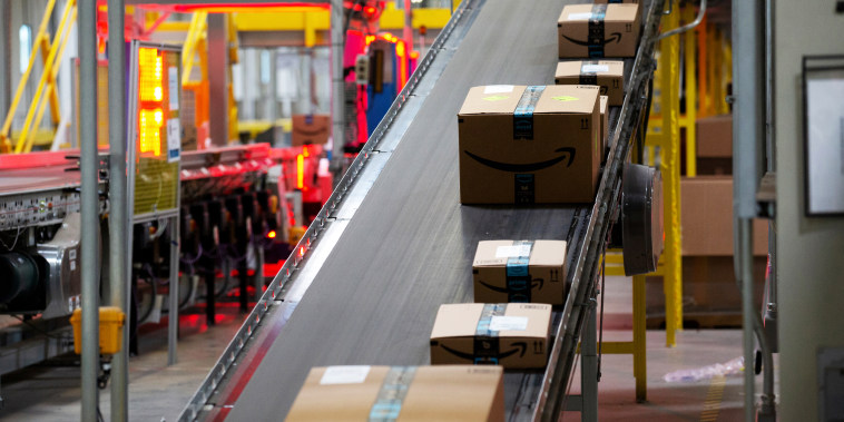 Packages move along a conveyor at the Amazon fulfillment center in Robbinsville, N.J., on June 7, 2018.