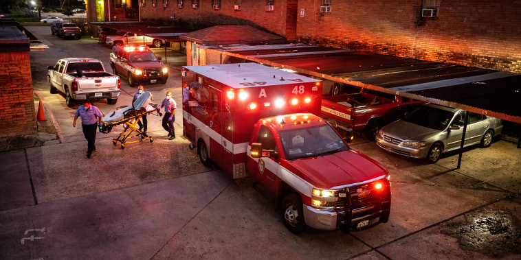 Houston Fire Department paramedics prepare to transport a Covid-19 positive woman to a hospital on Sept. 15, 2021 in Houston, Texas.