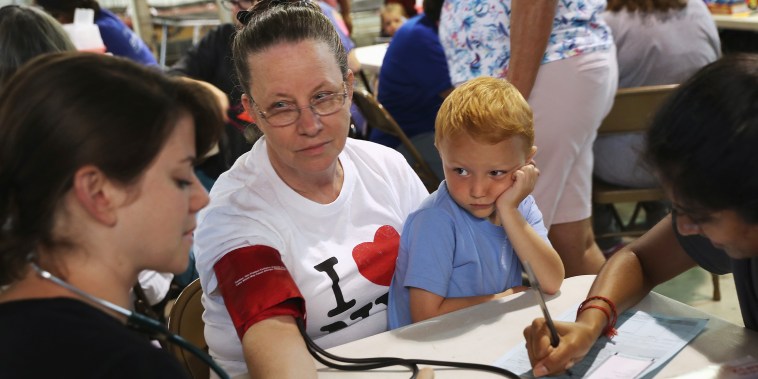 Image: Ruby Partin, 63, and her adoptive son Timothy Huff, 5, visit the free annual Remote Area Medical health clinic on July 22, 2017 in Wise, Va.