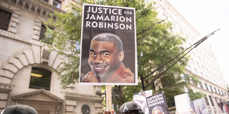 Protesters march through the streets of Atlanta to call for the arrest of police officers involved in the killing of Jamarion Robinson in Atlanta, on June 20, 2020.