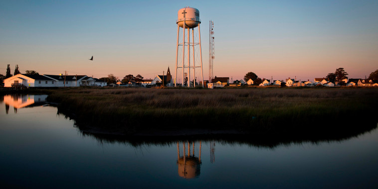 Image: The sun sets in Tangier, Va., on May 15, 2017,  where climate change and rising sea levels threaten the inhabitants of the slowly sinking island.