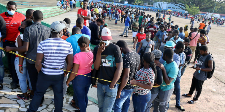 Migrants, mostly Haitians, wait in line for asylum processing by Mexico's Commission for Refugee Assistance in Tapachula, Mexico, on Oct. 18, 2021.