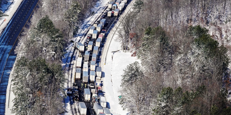 Image: Drivers wait for the traffic to be cleared as cars and trucks are stranded on sections of Interstate 95 on Jan. 4, 2022, in Carmel Church, Va.