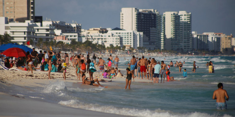 Beachgoers in Cancun, Mexico, on Dec. 27, 2021.