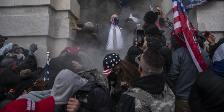 Image: Demonstrators attempt to breach the Capitol after they had stormed the building on Jan. 6, 2021.