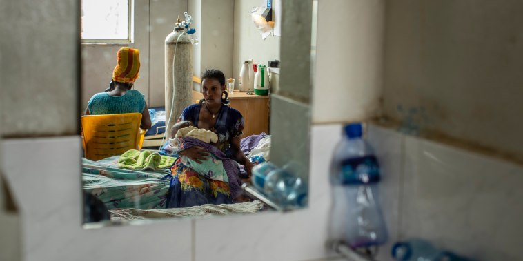 Tekien Tadese, 25, holds her baby, Amanuel Mulu, 22 months old, who is suffering from malnutrition at the Ayder Referral Hospital in Mekele, in the Tigray region of northern Ethiopia, on May 10, 2021.