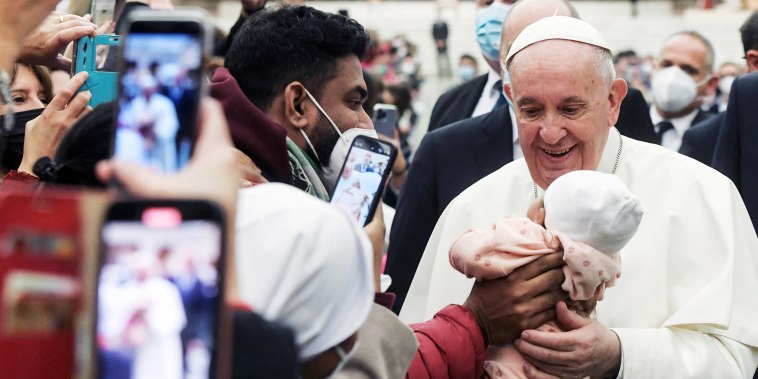 Image: Pope Francis meets a child after the weekly general audience at the Vatican on Jan. 5, 2022.