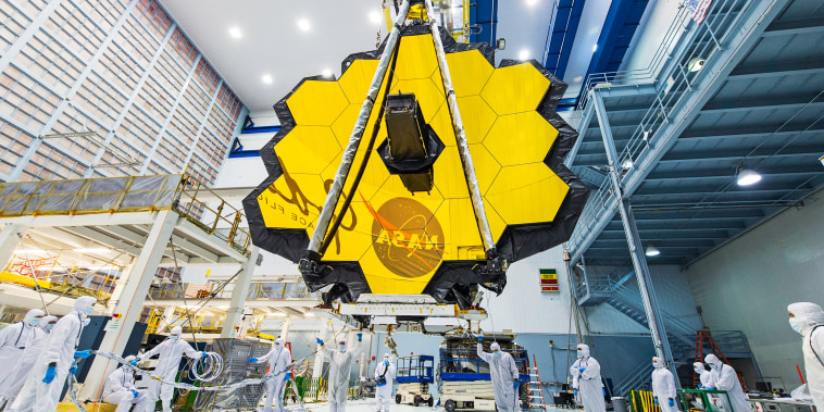 Image: NASA technicians lift the James Webb Telescope with a crane and move it inside a clean room at NASA’s Goddard Space Flight Center in Greenbelt, Md.