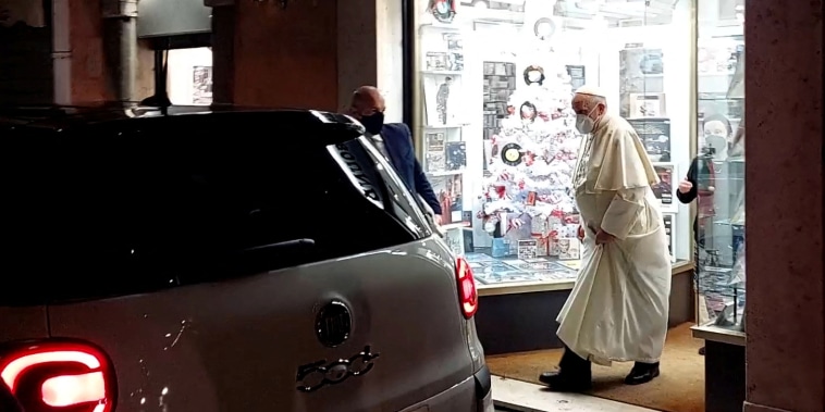 Image: Pope Francis walks out of a record shop in Rome on Jan. 11, 2022.