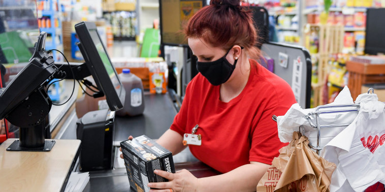A cashier scans a customer's groceries in Womelsdorf, Pa., on April 8, 2021.