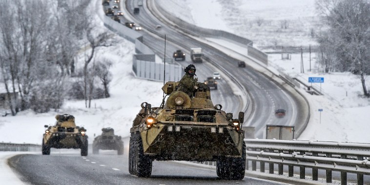 Image: A convoy of Russian armored vehicles moves along a highway in Crimea, on Jan. 18, 2022.