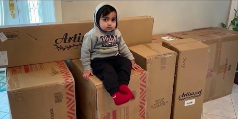 Ayaansh Kumar sits on some on boxes containing some of the furniture he ordered from Walmart.com.