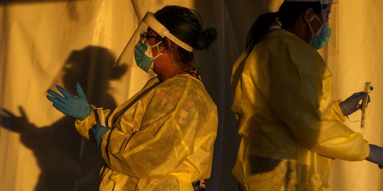 Image: Healthcare workers at a drive-thru Covid-19 testing site in El Paso, Texas, on Jan. 12, 2022.