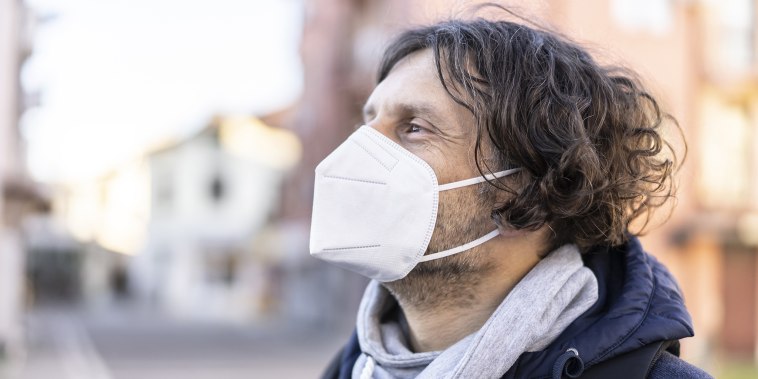 Portrait of a man wearing a protective face mask in accordance with the European health guidelines.