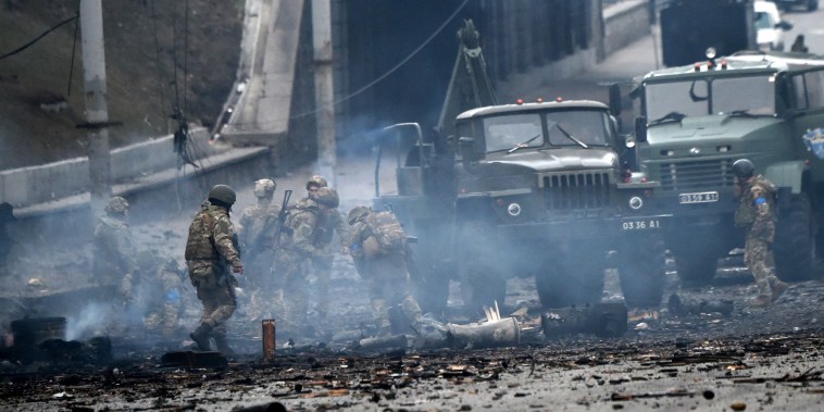 Image: Ukrainian service members collect unexploded shells in Kyiv, Ukraine, on Feb. 26, 2022.